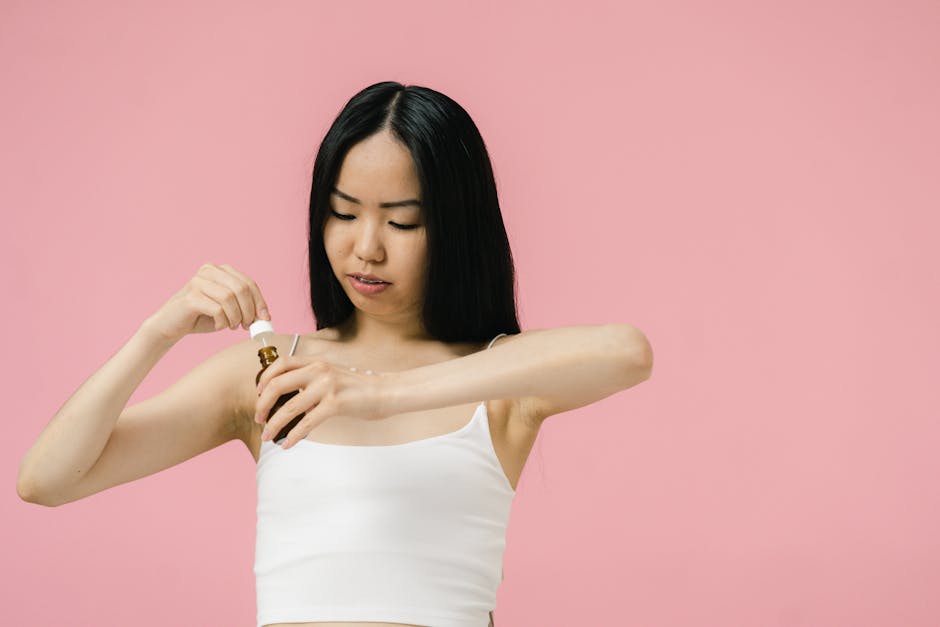 woman applying vitamin C serum on face morning skincare routine