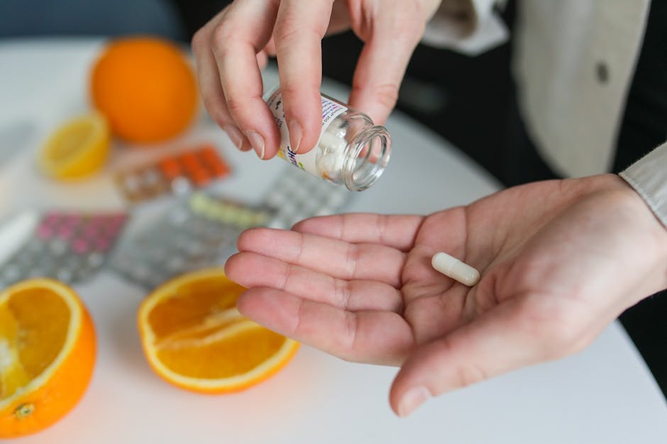 woman taking vitamin C supplement with glass of water morning light