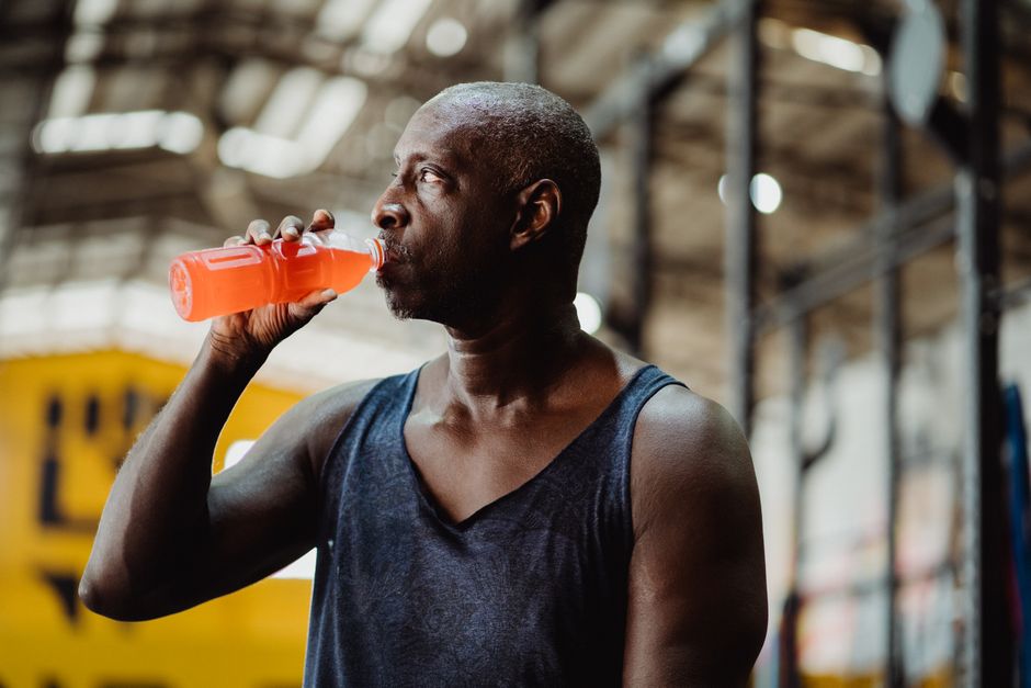 athlete drinking vitamin C supplement after workout gym